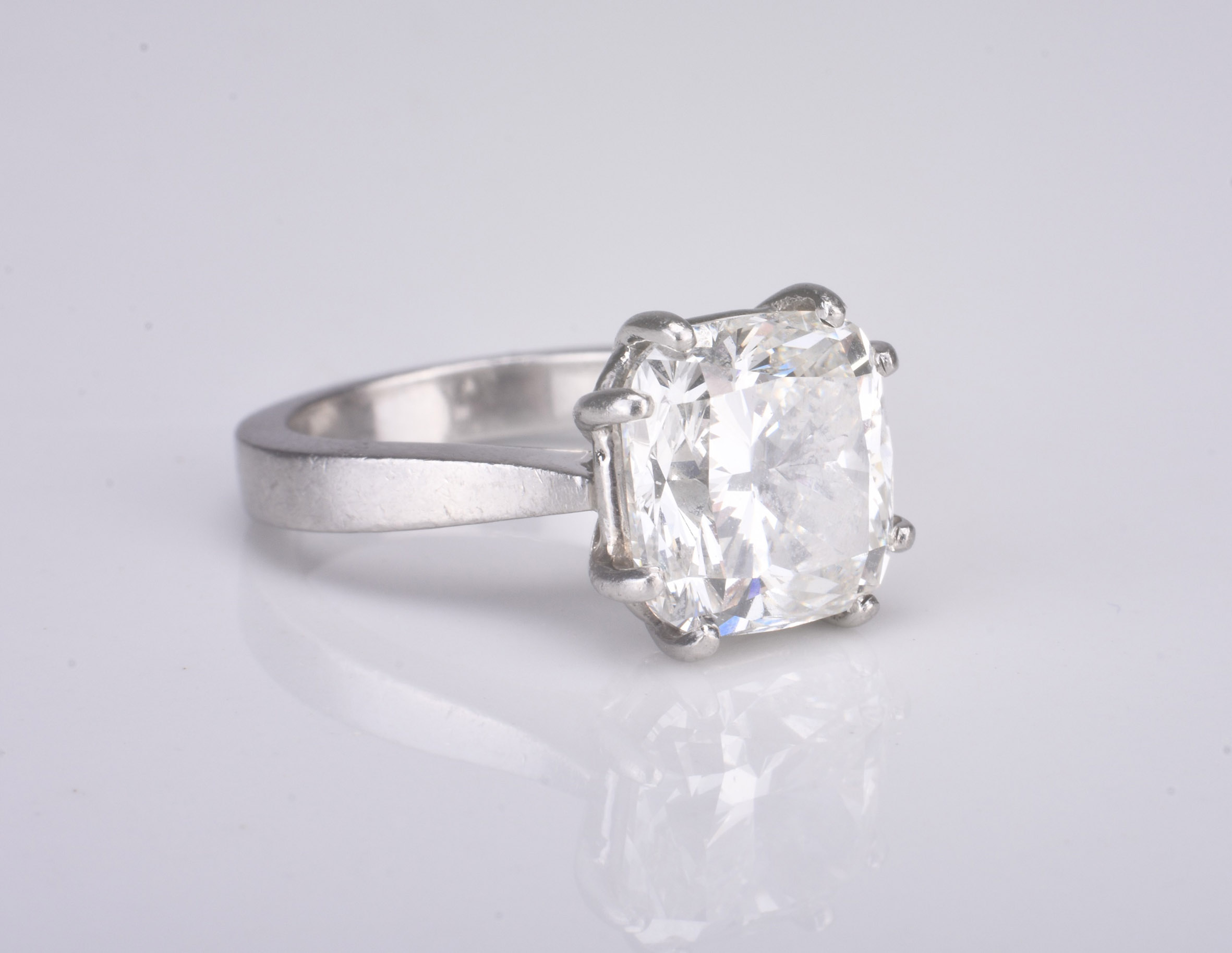 A platinum single stone cushion cut diamond ring Sold for £22,000 Halls Fine Art